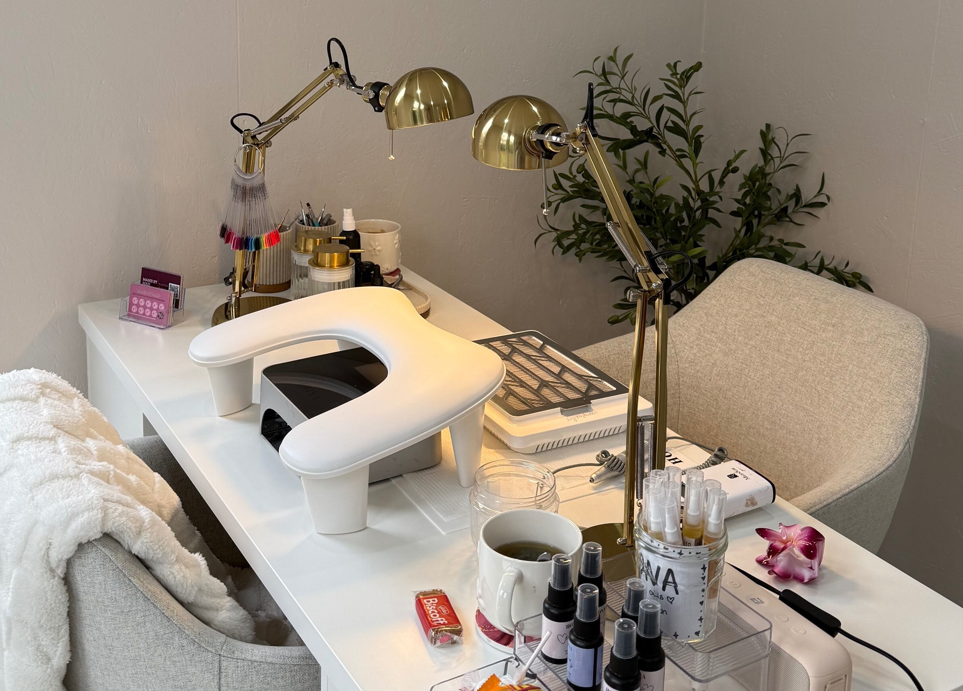 Chic nail salon setup at Manis By Mais, Epsom, England, GB with cozy chair and sleek decor.
