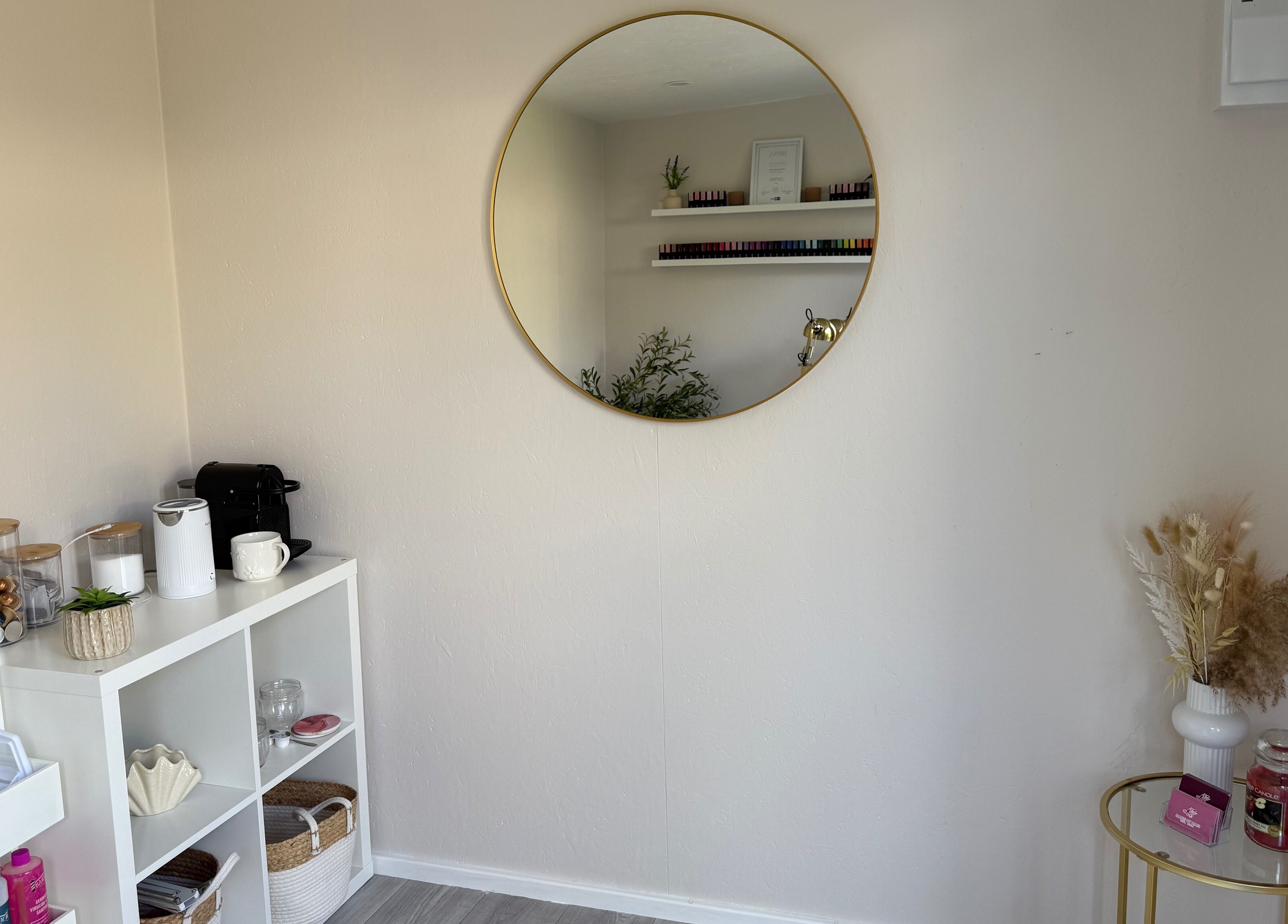 Elegant corner with a round mirror at Manis By Mais in Epsom, England, GB.