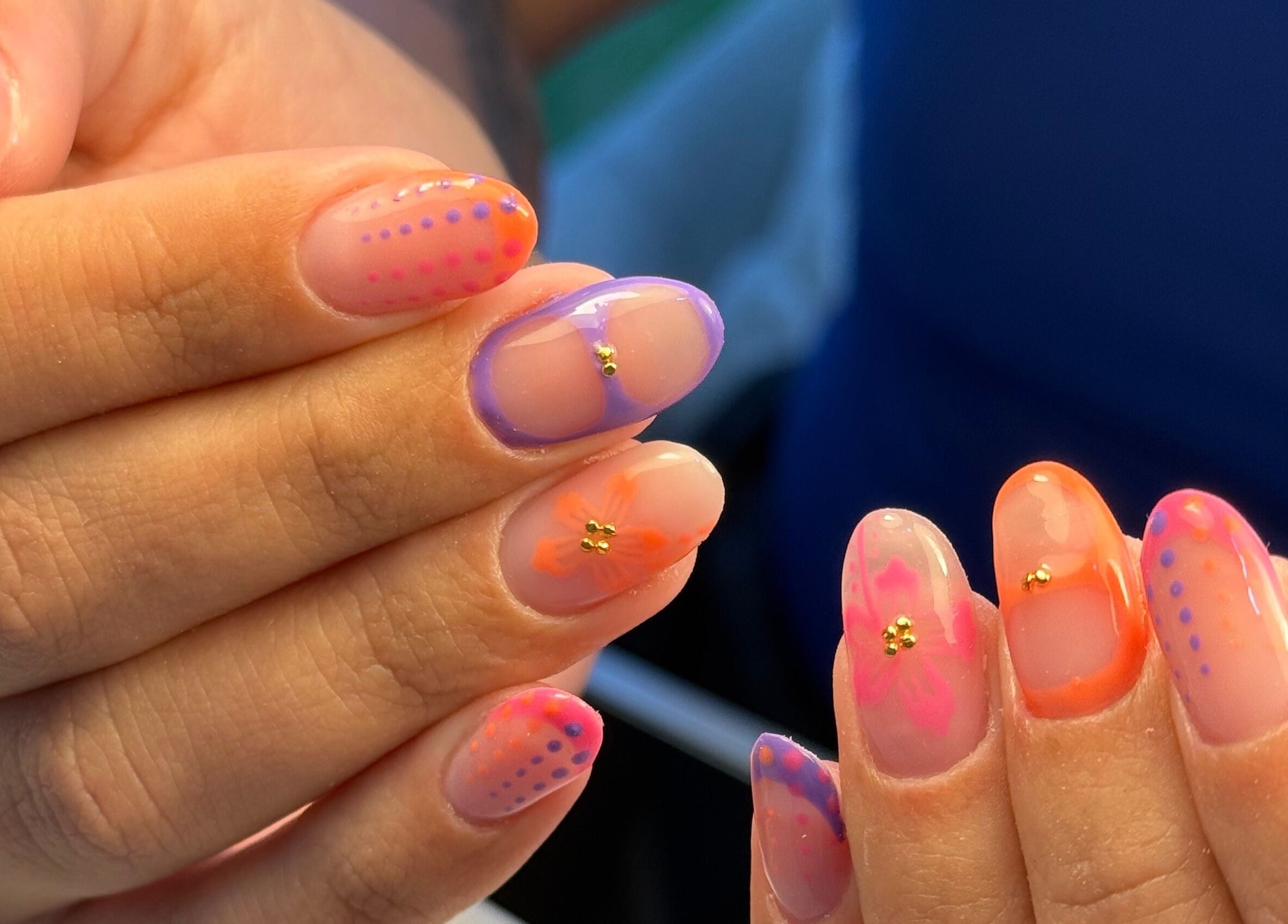 Colorful nail art design at Manis By Mais, Epsom, England, GB, featuring intricate patterns and bold colors.