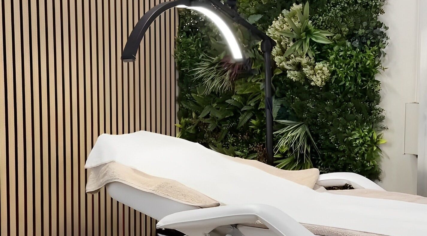 Luxury treatment bed at Beauty Boutique in Lichfield, England, GB, surrounded by lush greenery.