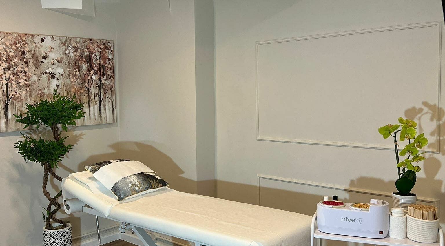 Relaxing treatment room at City Wax Studio, London, England, GB, featuring a calming art piece and elegant decor.