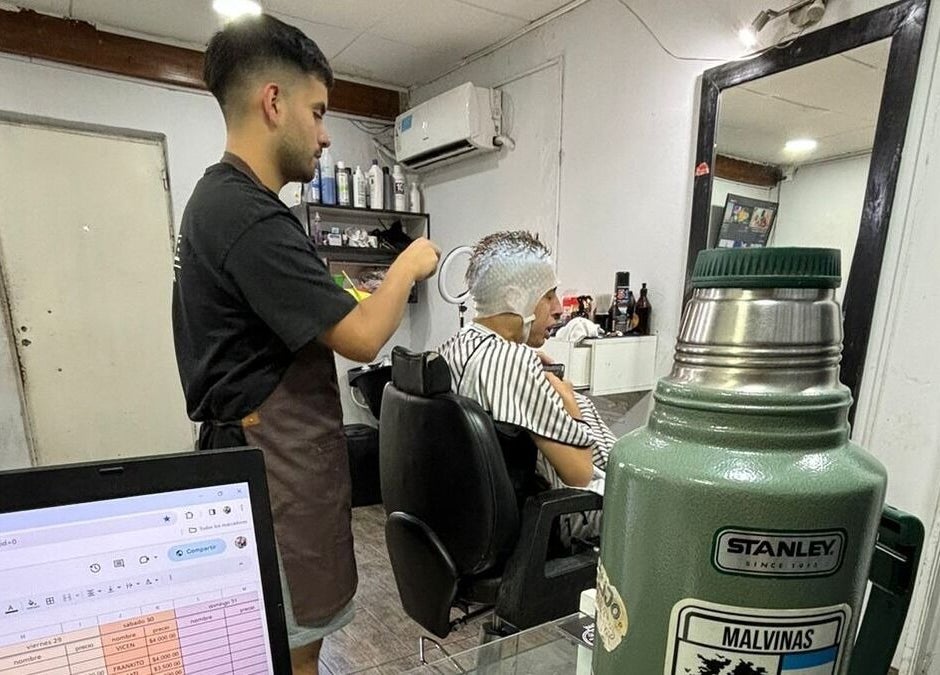 Interior de Costabile Salón Masculino en La Tablada, estilista trabajando en un cliente con gorra térmica.