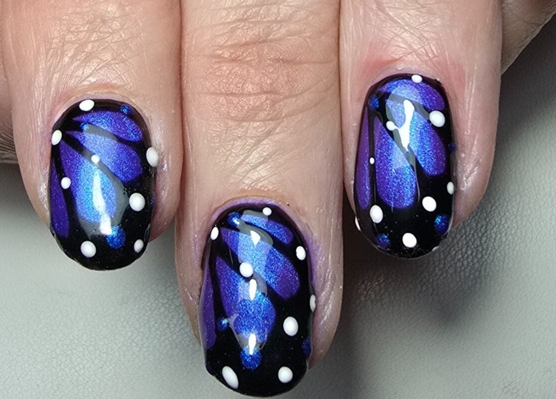 Butterfly nail art design at Nails by Nicole, Oughtibridge, England, GB showcasing vibrant blue and black patterns.