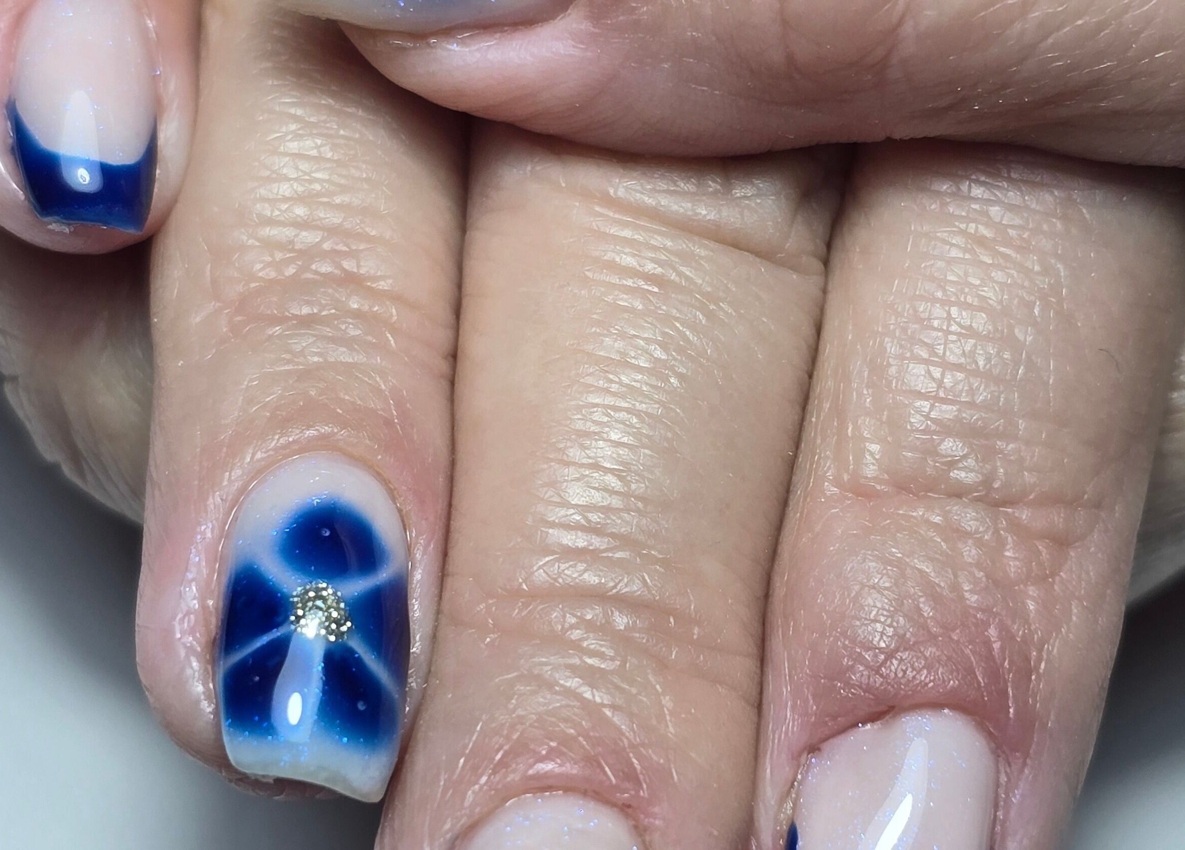 Elegant blue floral nail art at Nails by Nicole, Oughtibridge, England, GB. Perfect for any occasion.