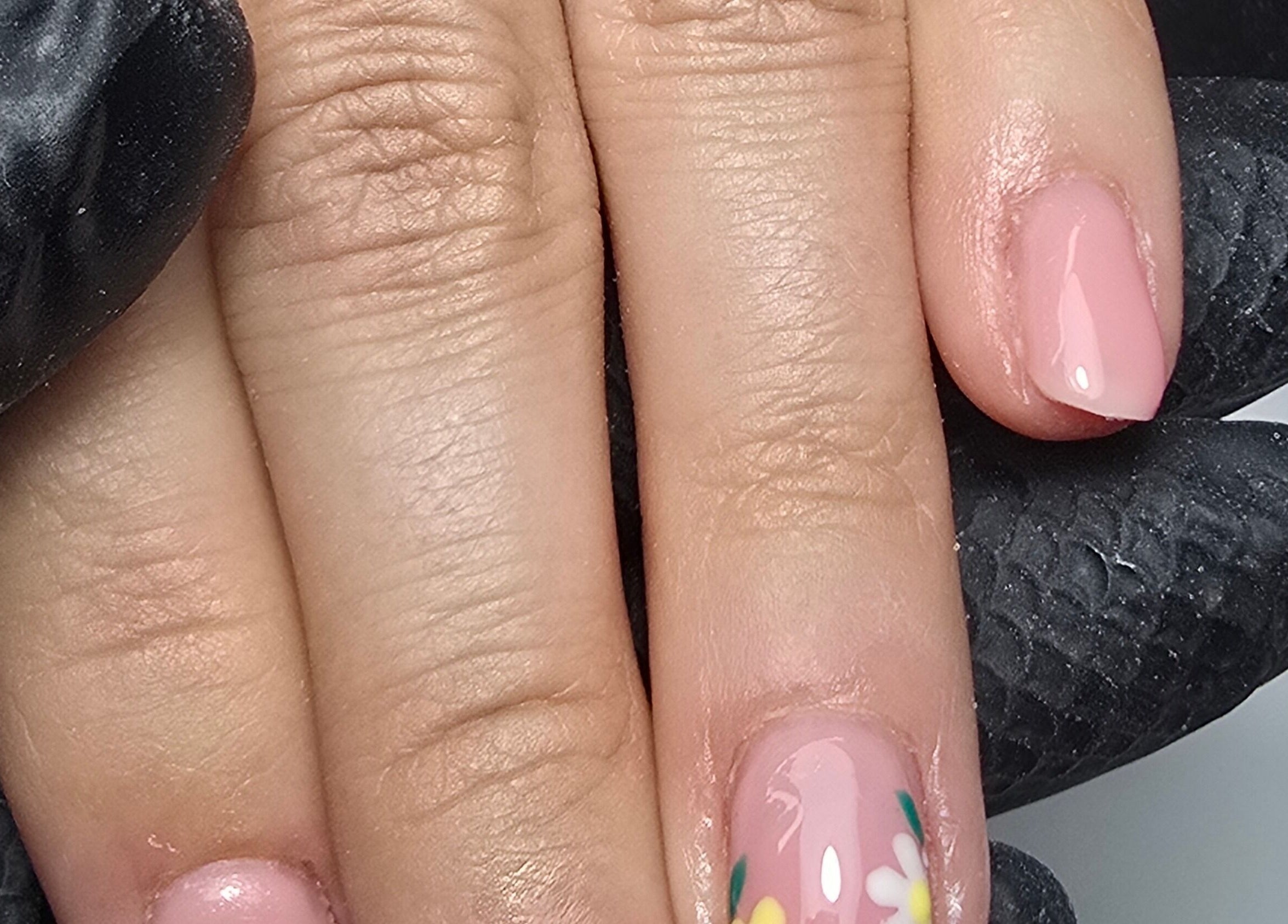 Floral nail art on manicured hand at Nails by Nicole in Oughtibridge, England, GB.