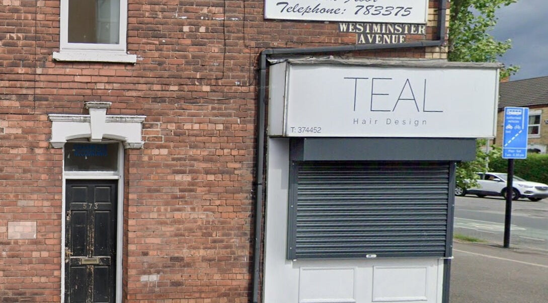Front view of Teal Hair Design, Hull, England, GB, featuring a stylish signage and brick structure.