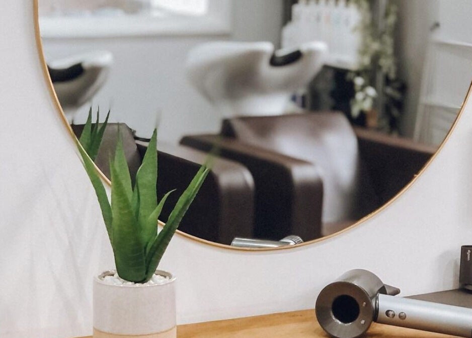Modern salon setup at Teal Hair Design in Hull, England, GB, featuring stylish mirror and equipment.