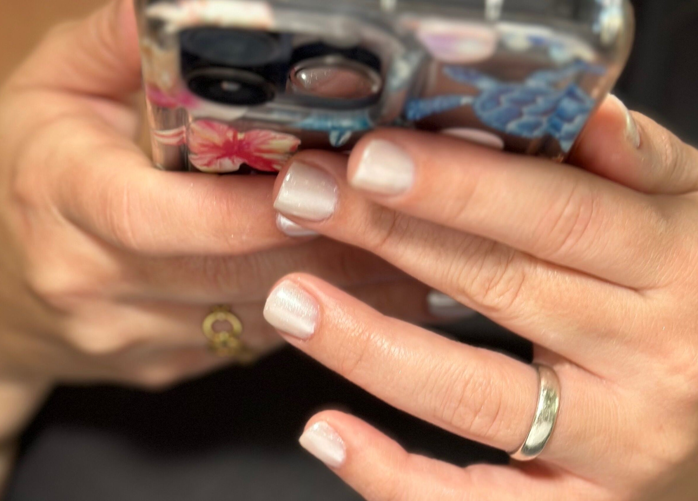 Close-up of chic manicured hands holding a phone at Nails by Kelly, Hollywood, Florida, US.