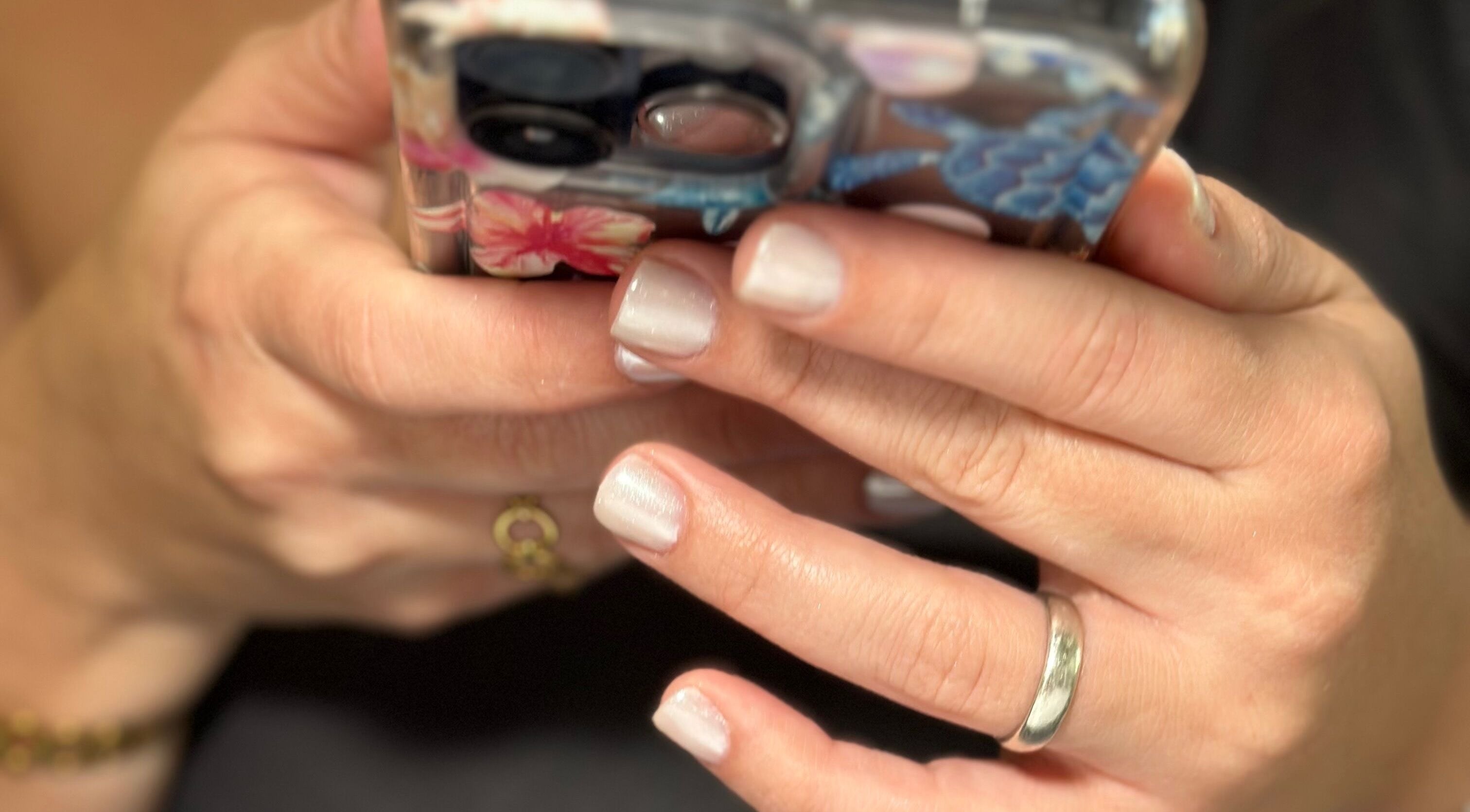 Close-up of chic manicured hands holding a phone at Nails by Kelly, Hollywood, Florida, US.
