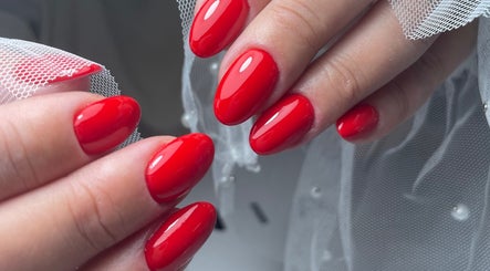 Vibrant red manicure at ŻanaNailsStudio, Edinburgh, Scotland, GB showcasing exquisite nail artistry.