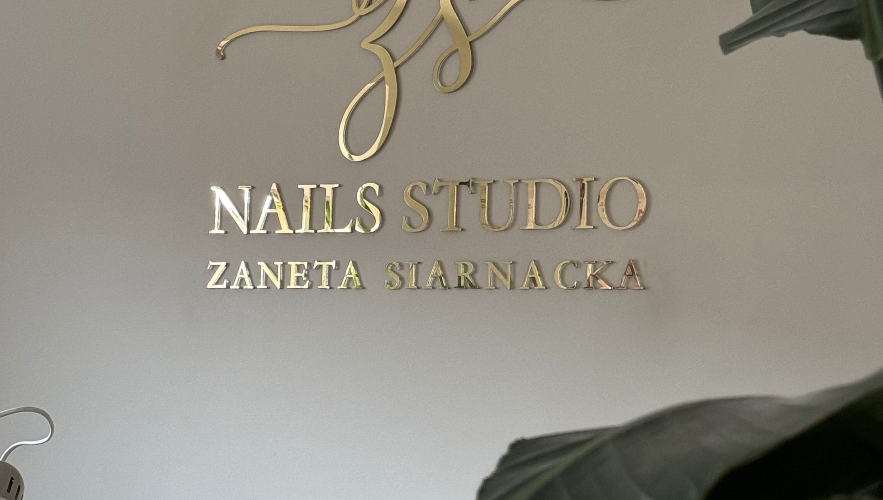 ŻanaNailsStudio gold signage in Edinburgh, Scotland, GB, showcasing elegant branding.