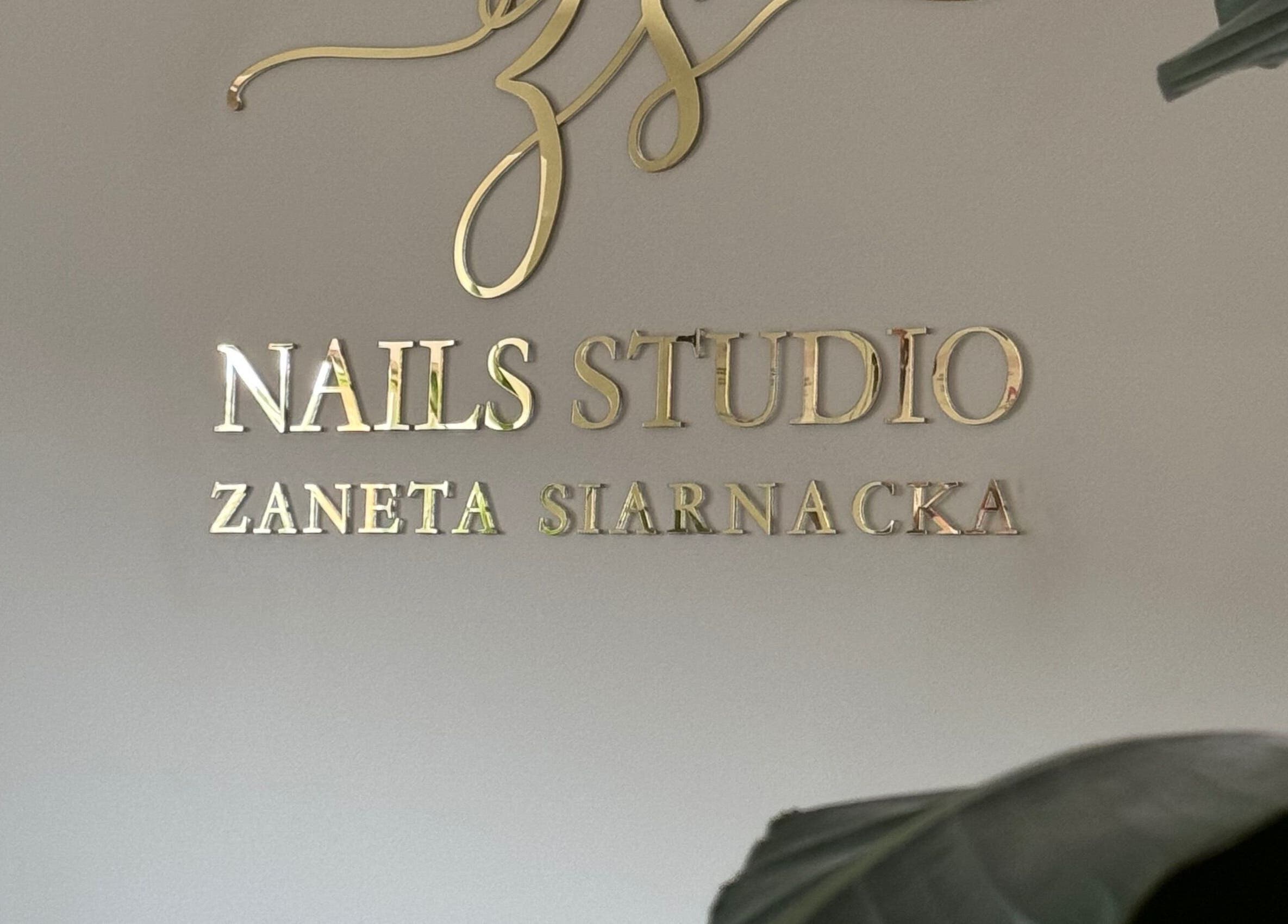 ŻanaNailsStudio gold signage in Edinburgh, Scotland, GB, showcasing elegant branding.