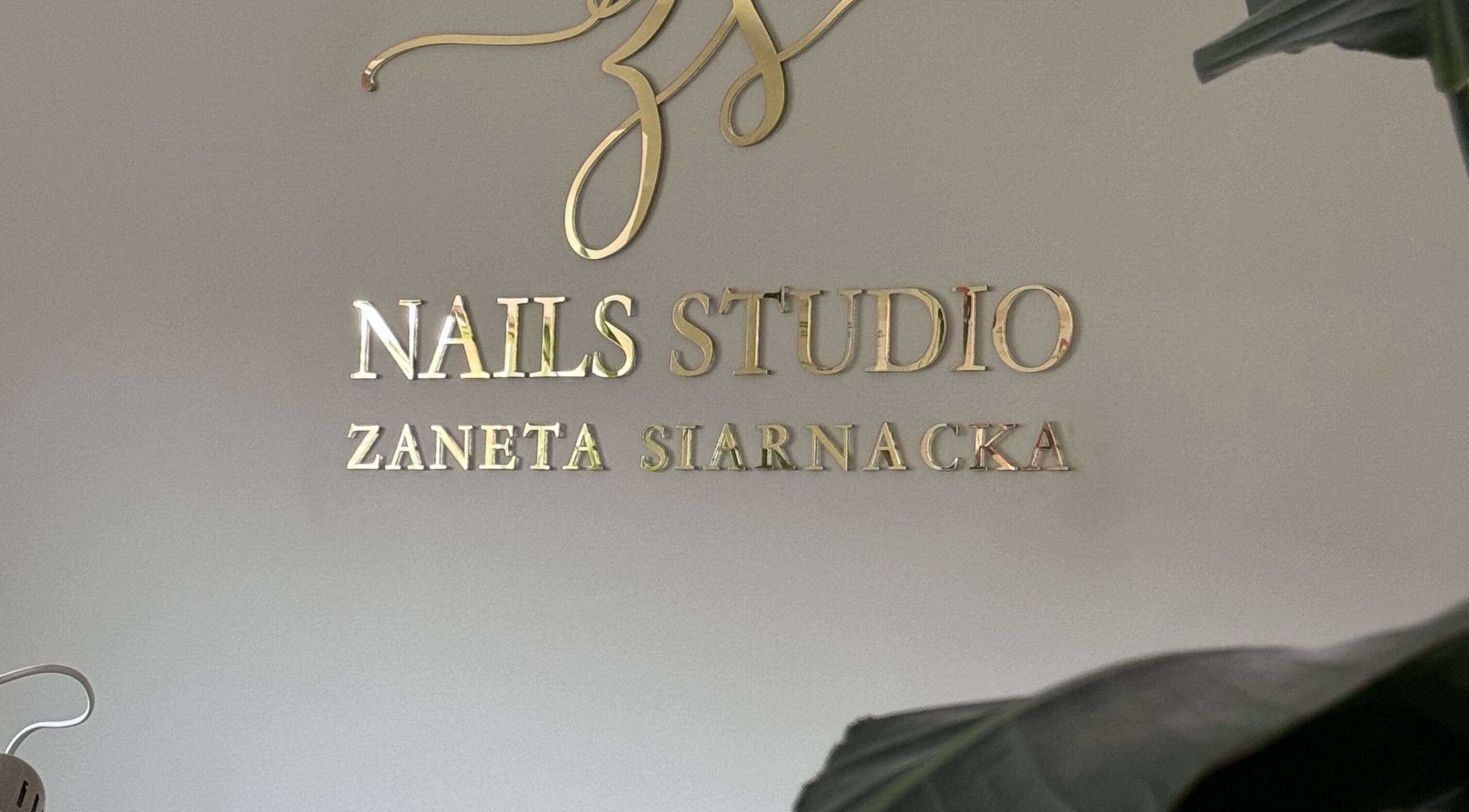 ŻanaNailsStudio gold signage in Edinburgh, Scotland, GB, showcasing elegant branding.