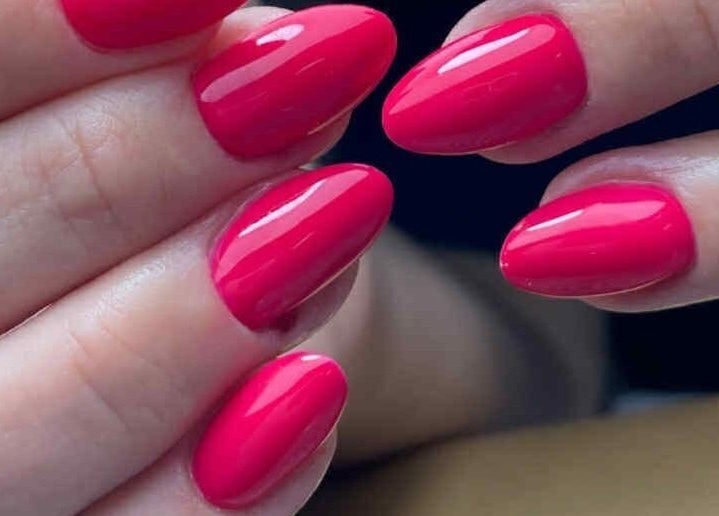 Bright pink gel nails at ŻanaNailsStudio, Edinburgh, Scotland, GB, showcasing expert nail artistry.