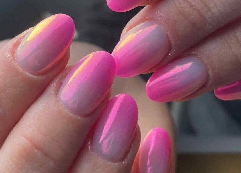 Vibrant pink nail art at ŻanaNailsStudio, Edinburgh, Scotland, GB, showcasing expert polish finish.