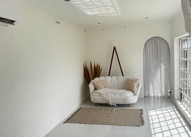 Bright studio at Morganite Photography in Alberton, Gauteng, ZA, featuring a cozy white sofa and natural light.