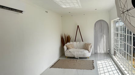 Bright studio at Morganite Photography in Alberton, Gauteng, ZA, featuring a cozy white sofa and natural light.