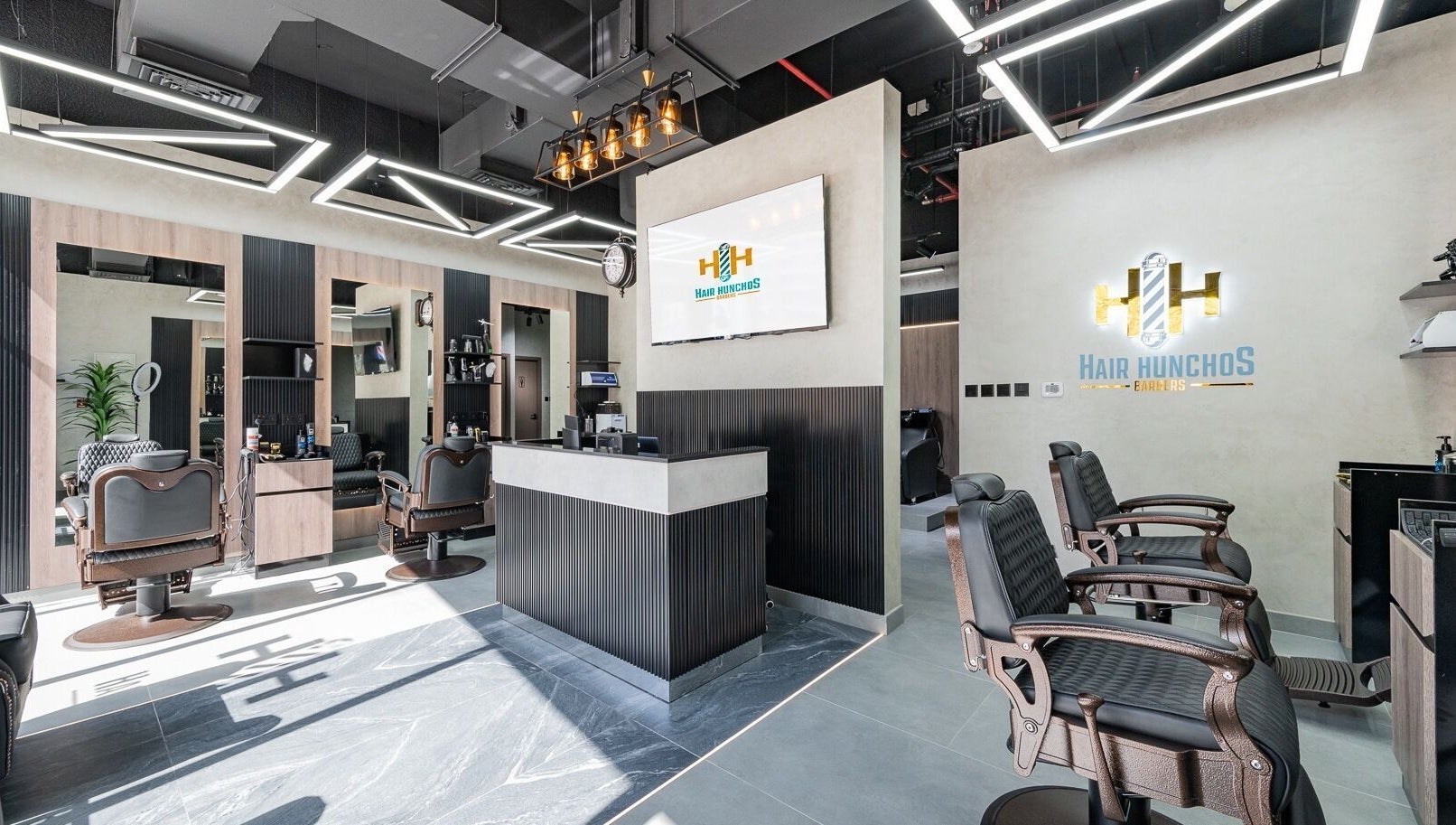 Chic interior of Hair Hunchos Barbers in Dubai, Dubai, AE showcases modern barber chairs and sleek decor.