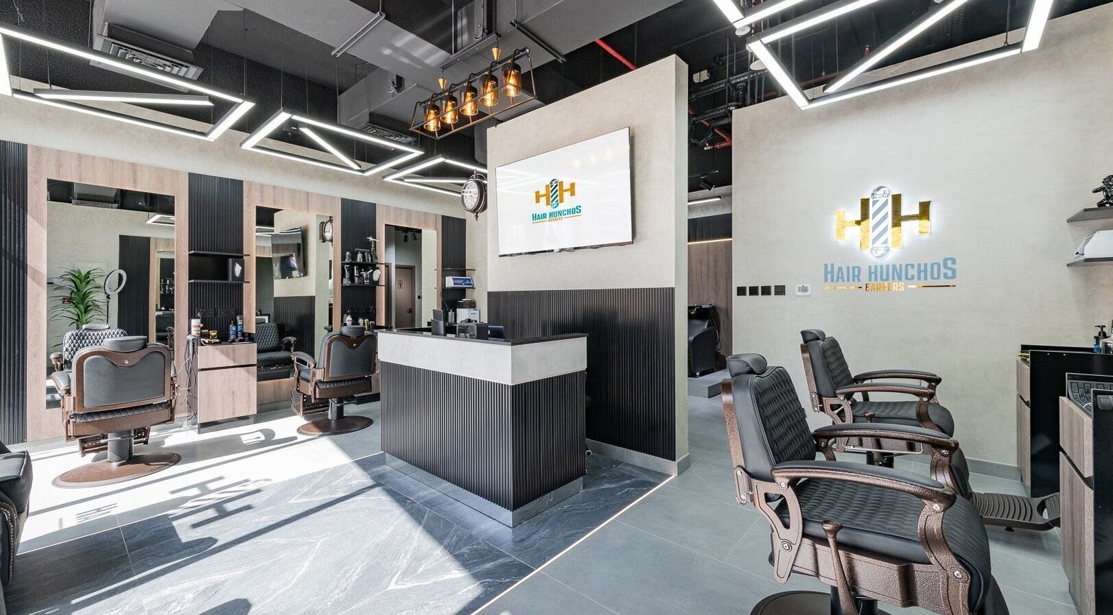Chic interior of Hair Hunchos Barbers in Dubai, Dubai, AE showcases modern barber chairs and sleek decor.