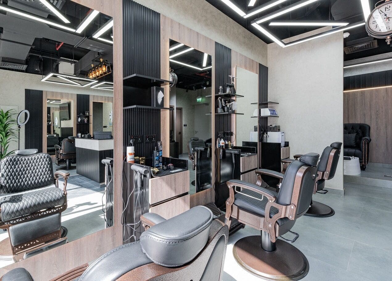 Modern interior of Hair Hunchos Barbers in Dubai, Dubai, AE, featuring stylish chairs and sleek design.