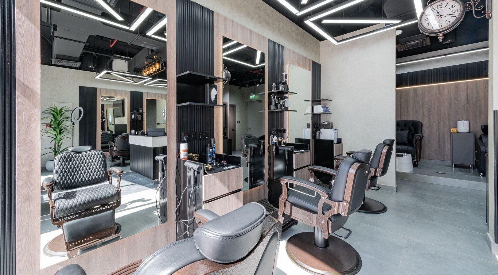 Modern interior of Hair Hunchos Barbers in Dubai, Dubai, AE, featuring stylish chairs and sleek design.