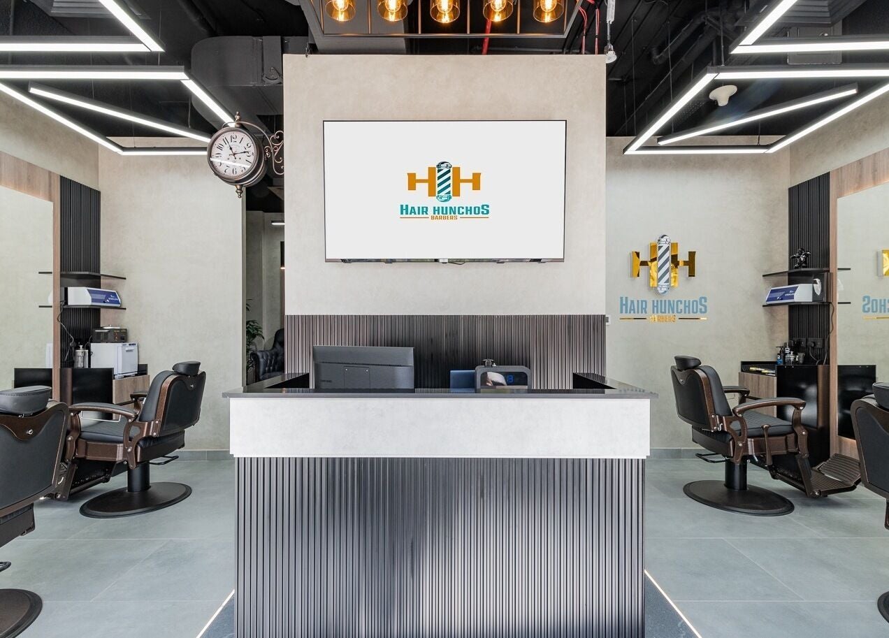 Modern interior of Hair Hunchos Barbers in Dubai, AE, featuring stylish chairs and sleek decor.