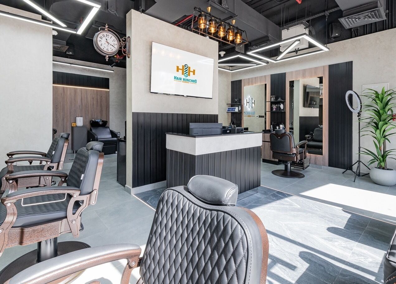 Modern interior of Hair Hunchos Barbers in Dubai, Dubai, AE, featuring stylish chairs and a welcoming reception.