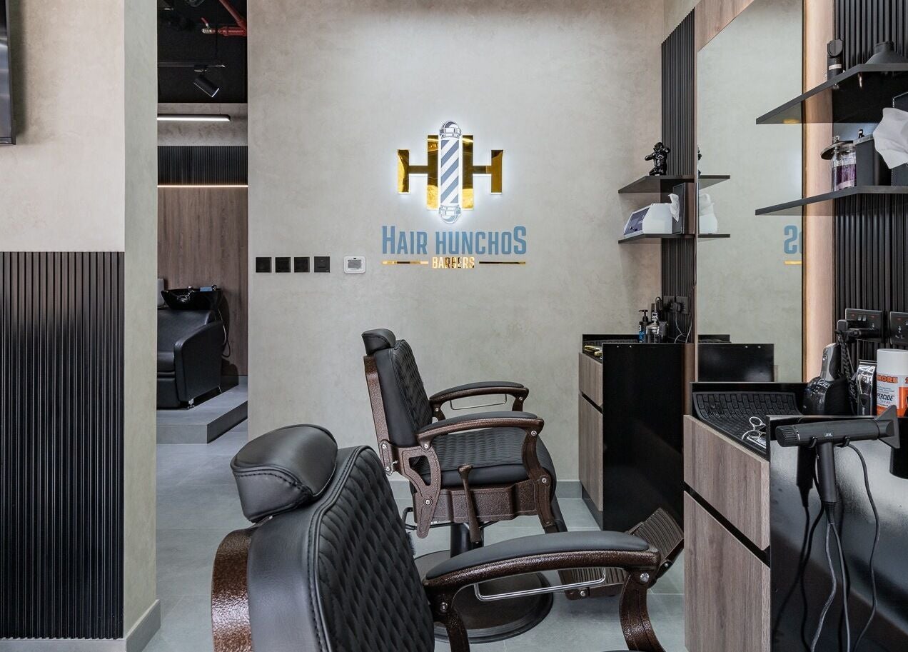 Chic interior of Hair Hunchos Barbers in Dubai, Dubai, AE, featuring modern barber chairs and styling tools.