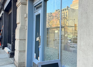 Entrance of New L&T Nail Spa INC located in New York, New York, US, with an inviting 'Open' sign.