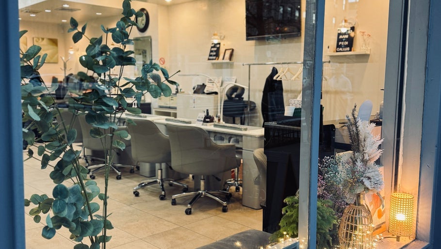 Inviting interior of New L&T Nail Spa INC in New York, New York, US elegantly styled with plants and cozy seating.