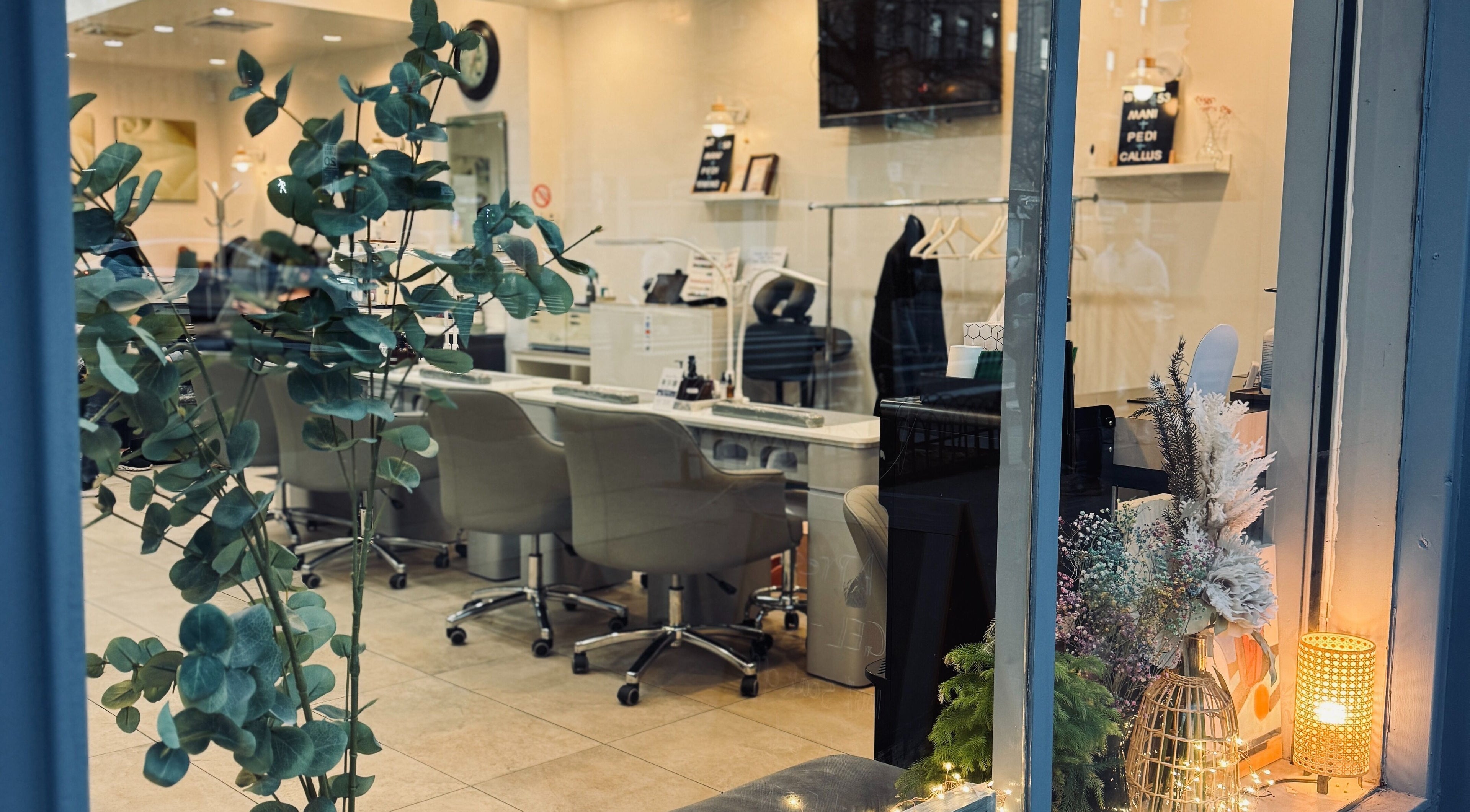 Inviting interior of New L&T Nail Spa INC in New York, New York, US elegantly styled with plants and cozy seating.