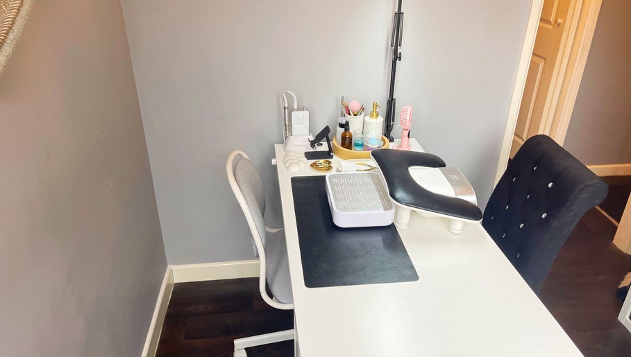 Elegant nail workstation at Lozzy Nails, Brentwood, England, GB, featuring manicure tools and plush chairs.