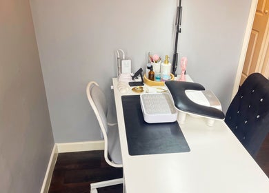 Elegant nail workstation at Lozzy Nails, Brentwood, England, GB, featuring manicure tools and plush chairs.