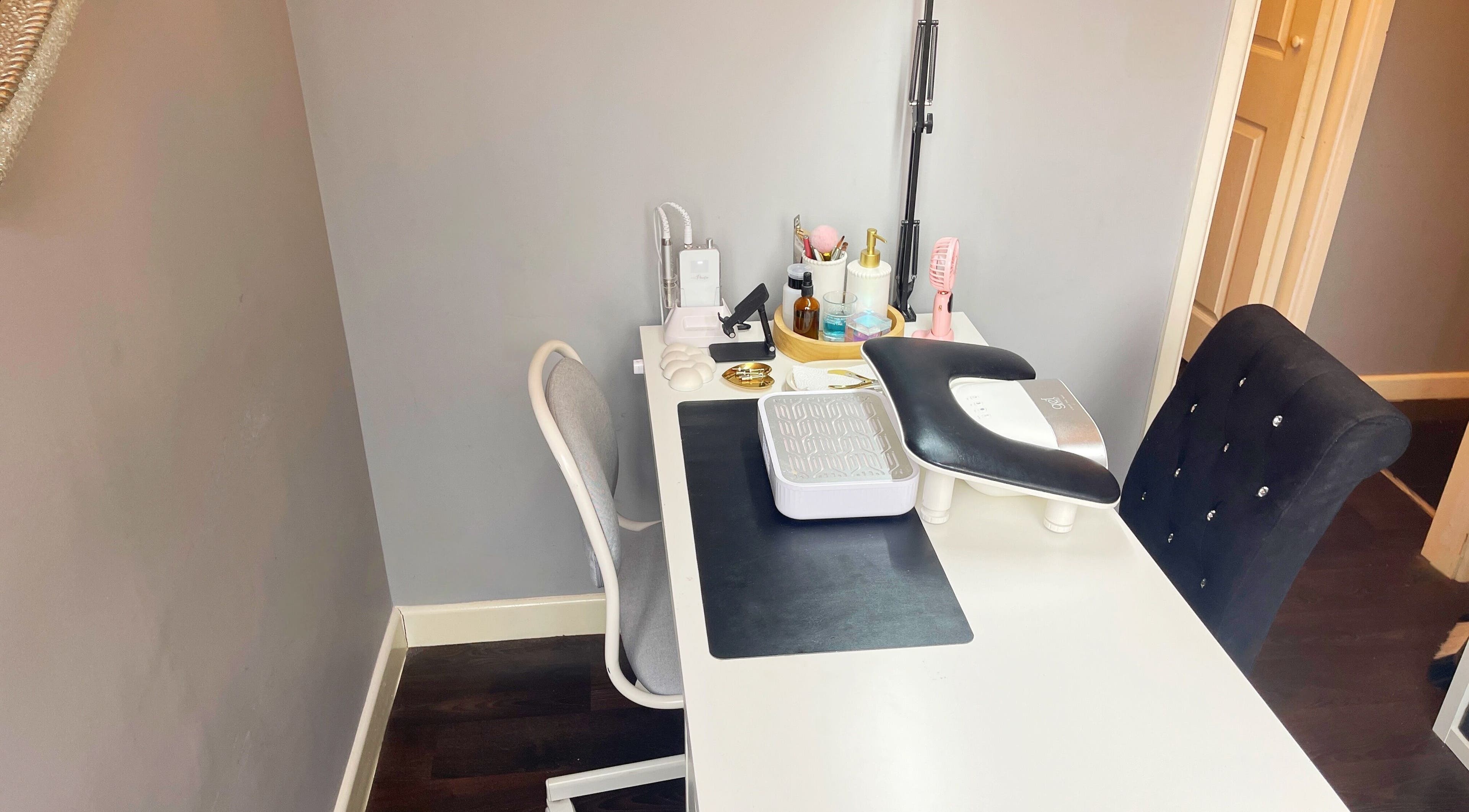 Elegant nail workstation at Lozzy Nails, Brentwood, England, GB, featuring manicure tools and plush chairs.