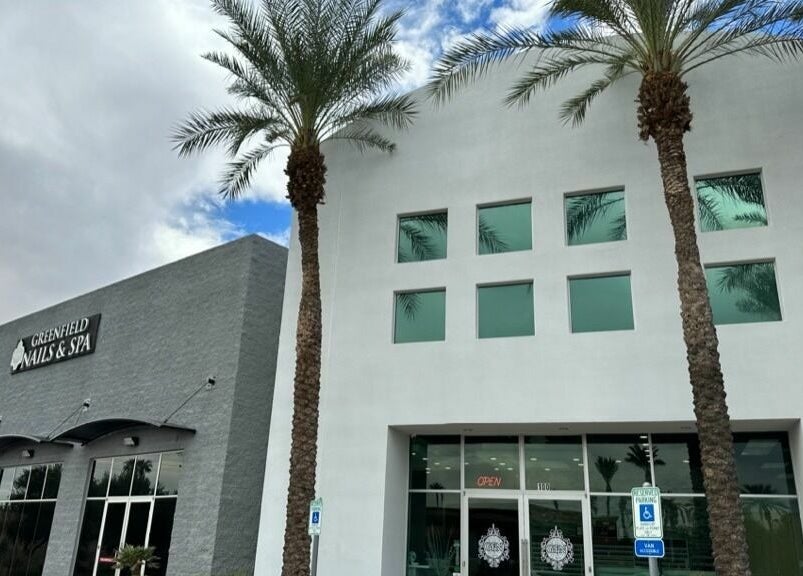 Front view of Greenfield Nails and Spa - Chandler in Chandler, Arizona, US with palm trees and clear skies.