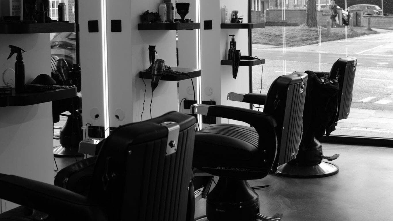 Stylish salon interior with black chairs at The Cut - Locksbottom, Orpington, England, GB.