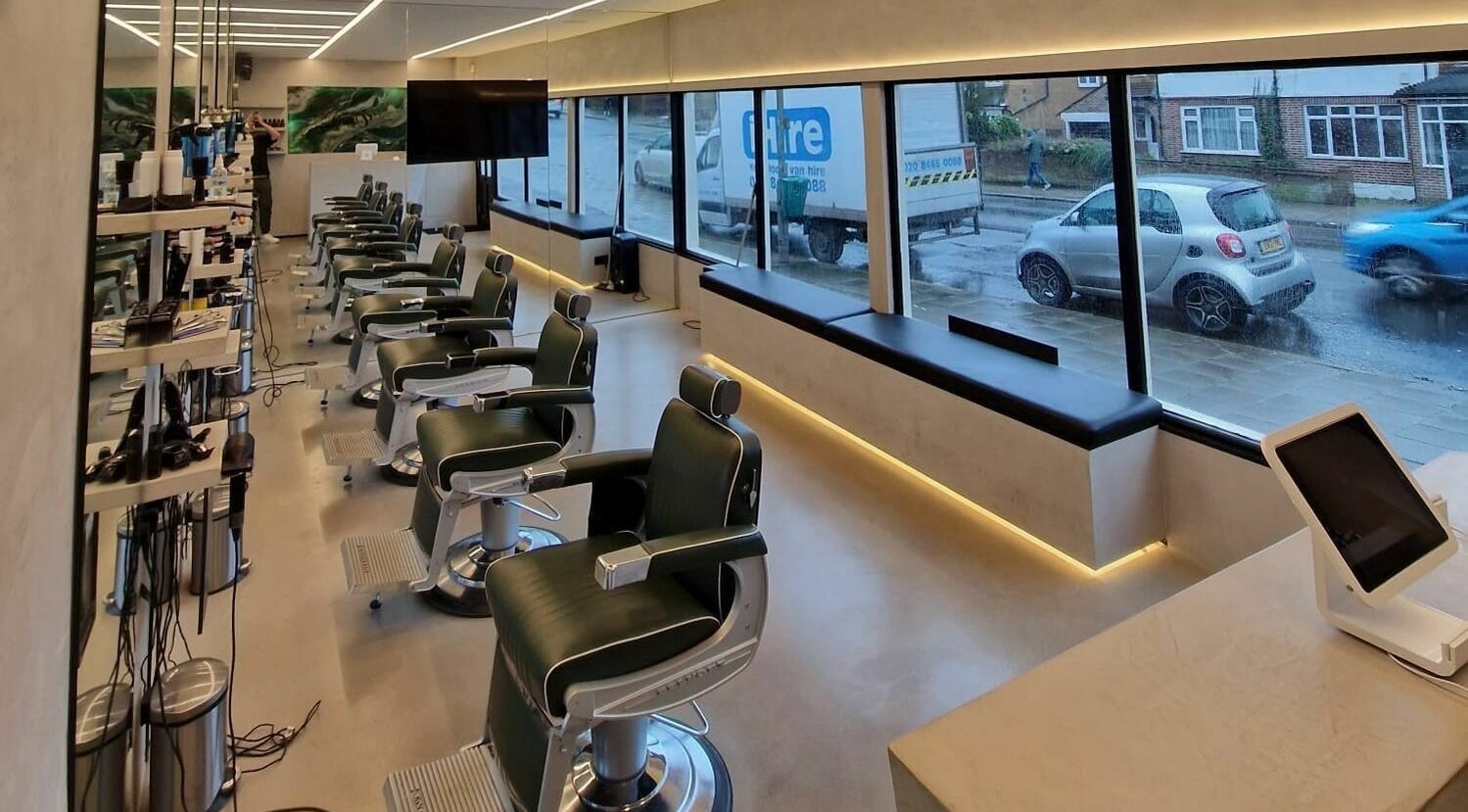 Modern salon interior at The Cut - Bickley, Bromley, England, GB, showcasing sleek barber chairs and large windows.