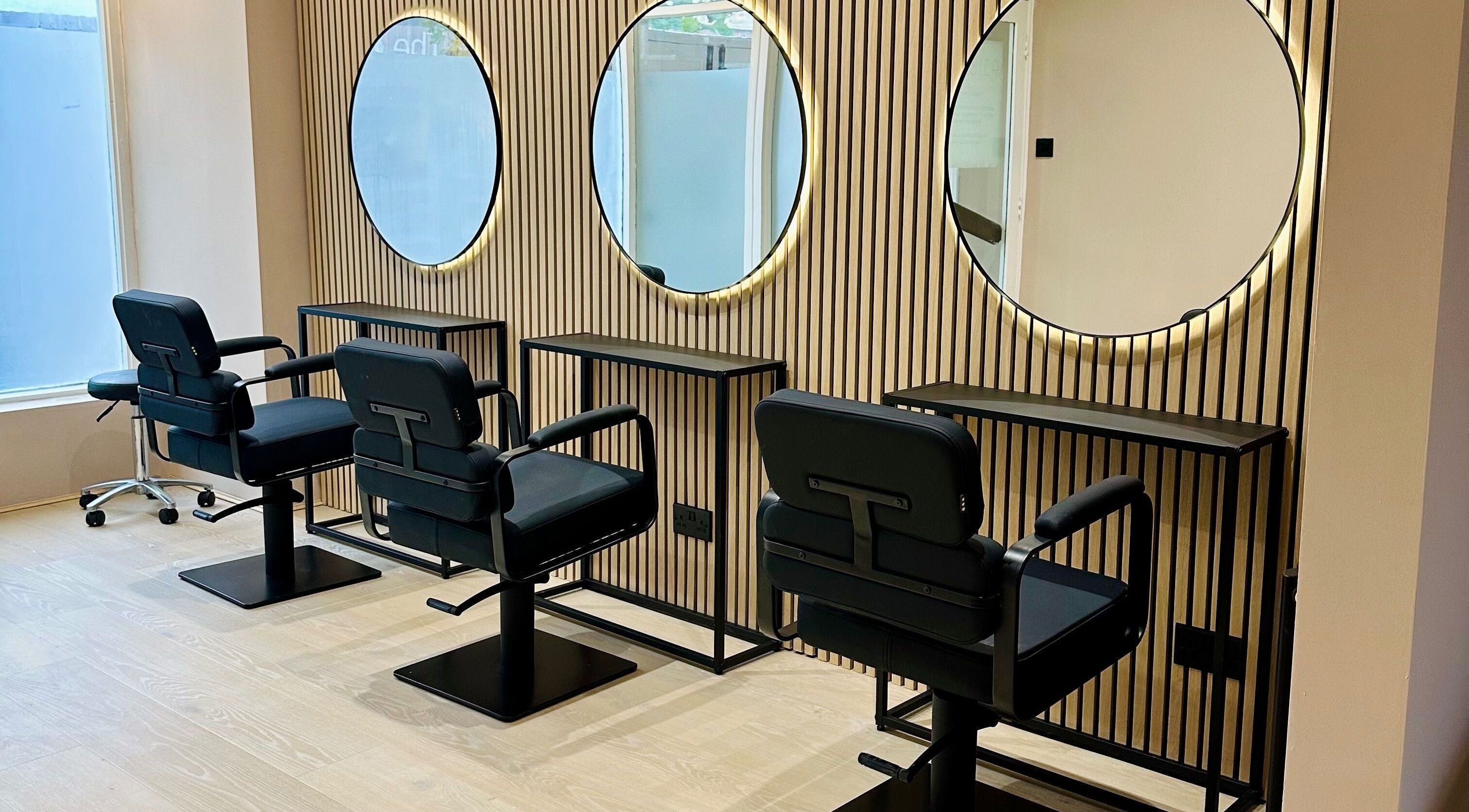 Modern salon chairs and mirrors at Causier in Wigston, England, GB for a stylish beauty experience.