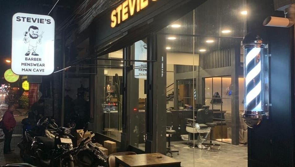 Stevie's Barber shop exterior in Bali, Bali, ID, featuring sleek design and illuminated barber pole.