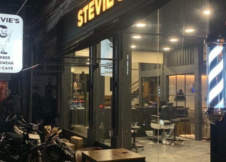 Stevie's Barber shop exterior in Bali, Bali, ID, featuring sleek design and illuminated barber pole.