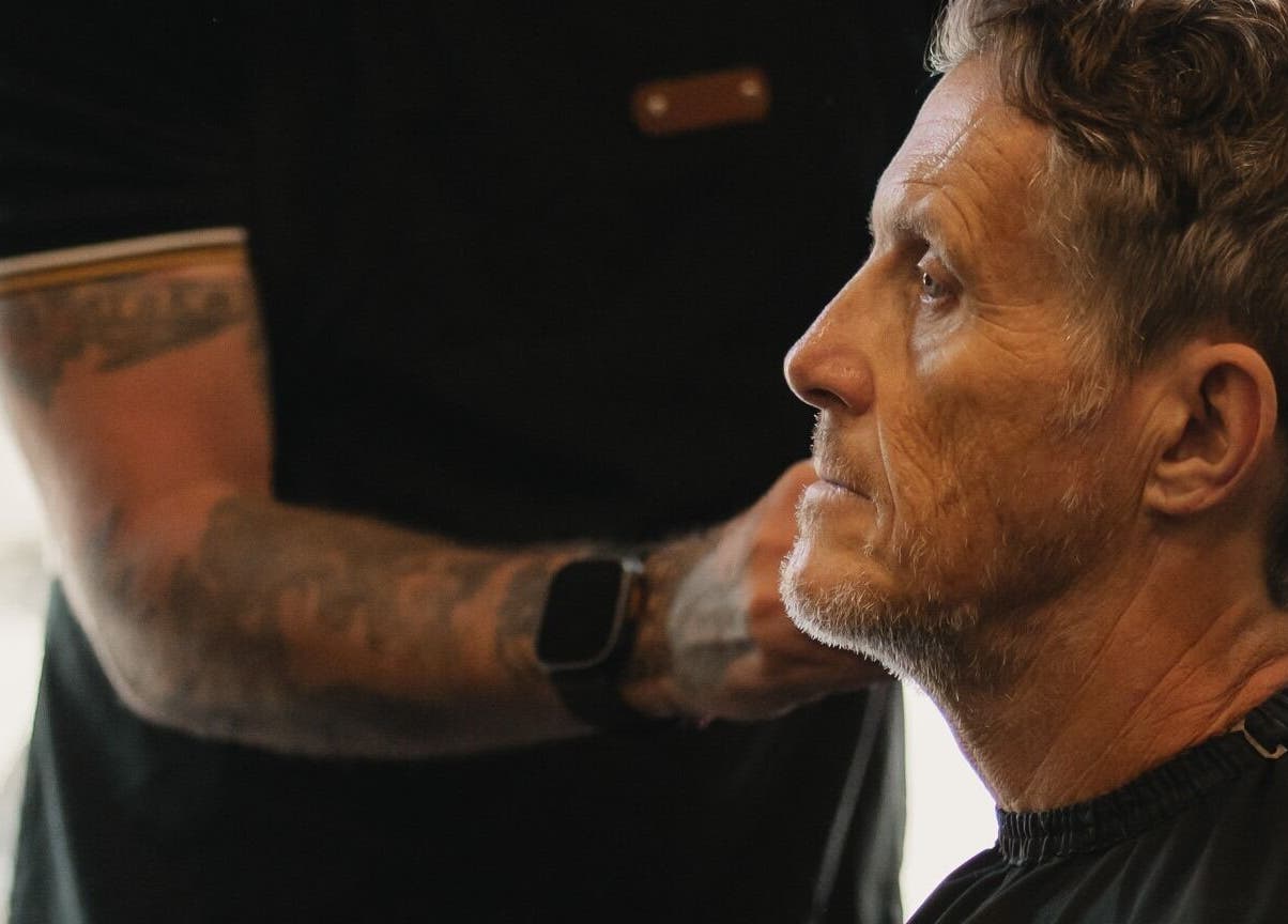 A gentleman receiving a haircut at Stevie's in Bali, Bali, ID. Experienced stylist in action.