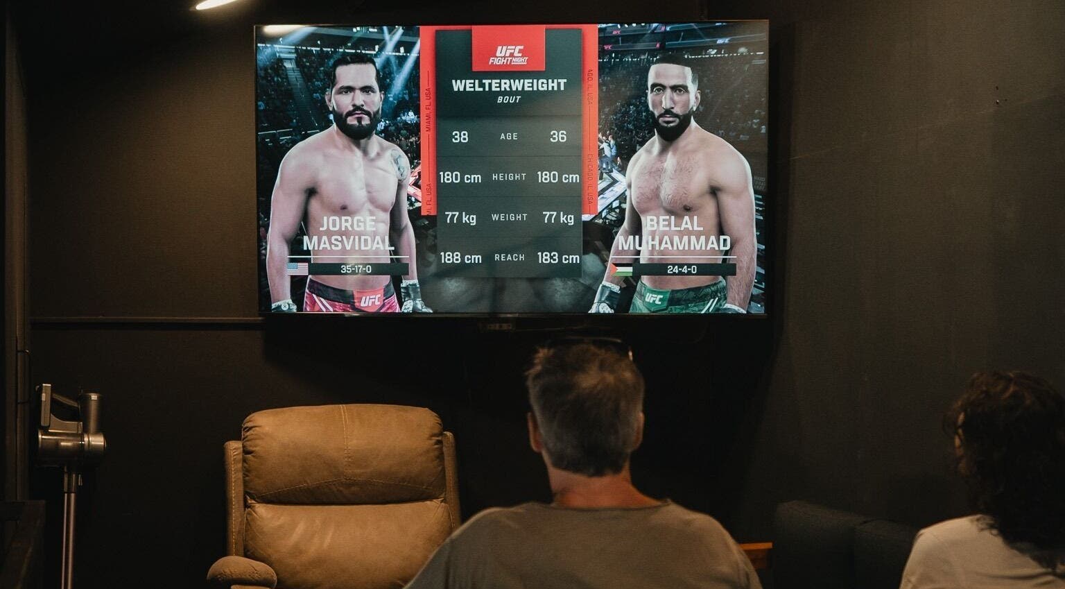 Guests at Stevie's in Bali, Bali, ID enjoy UFC fight on a large screen, seated comfortably.