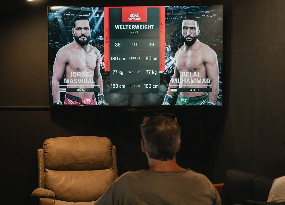 Guests at Stevie's in Bali, ID enjoy a UFC match screened in a cozy lounge setting.
