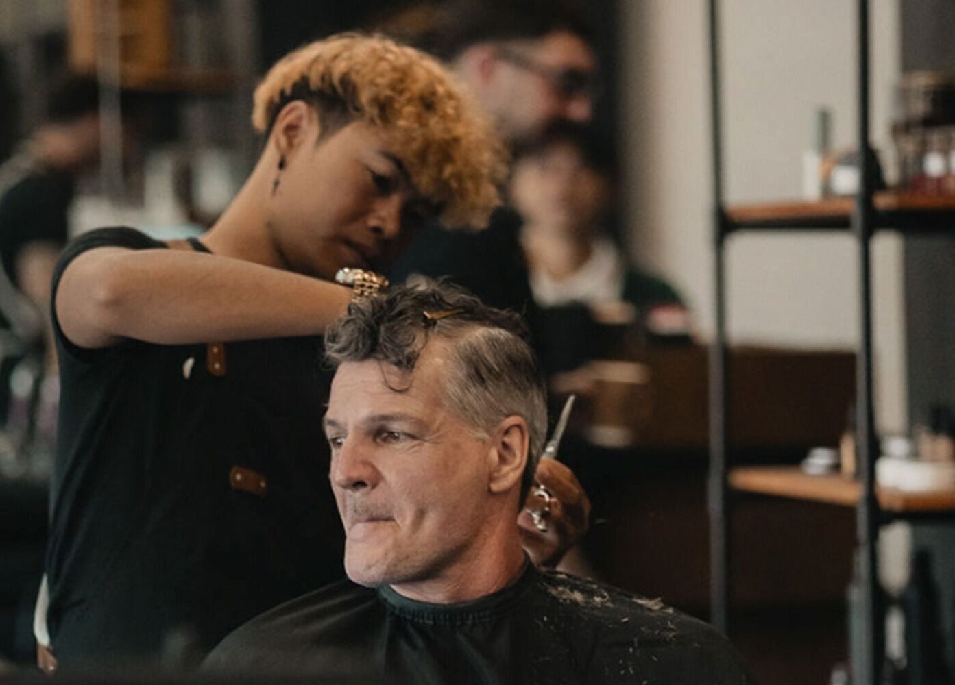 A skilled stylist at Stevie's in Bali, Bali, ID, gives a classic haircut to a customer.
