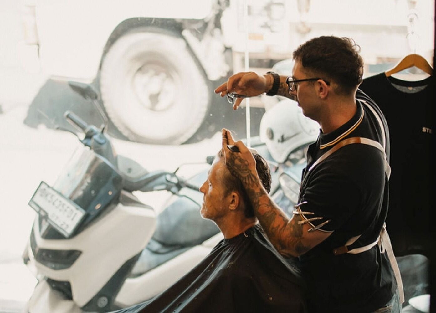 Skilled barber at Stevie's in Bali, Bali, ID, expertly styling a client's hair.