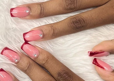 Elegant nail art with red tips at Princie Beauty, Johannesburg, Gauteng, ZA. Perfect for stylish looks.