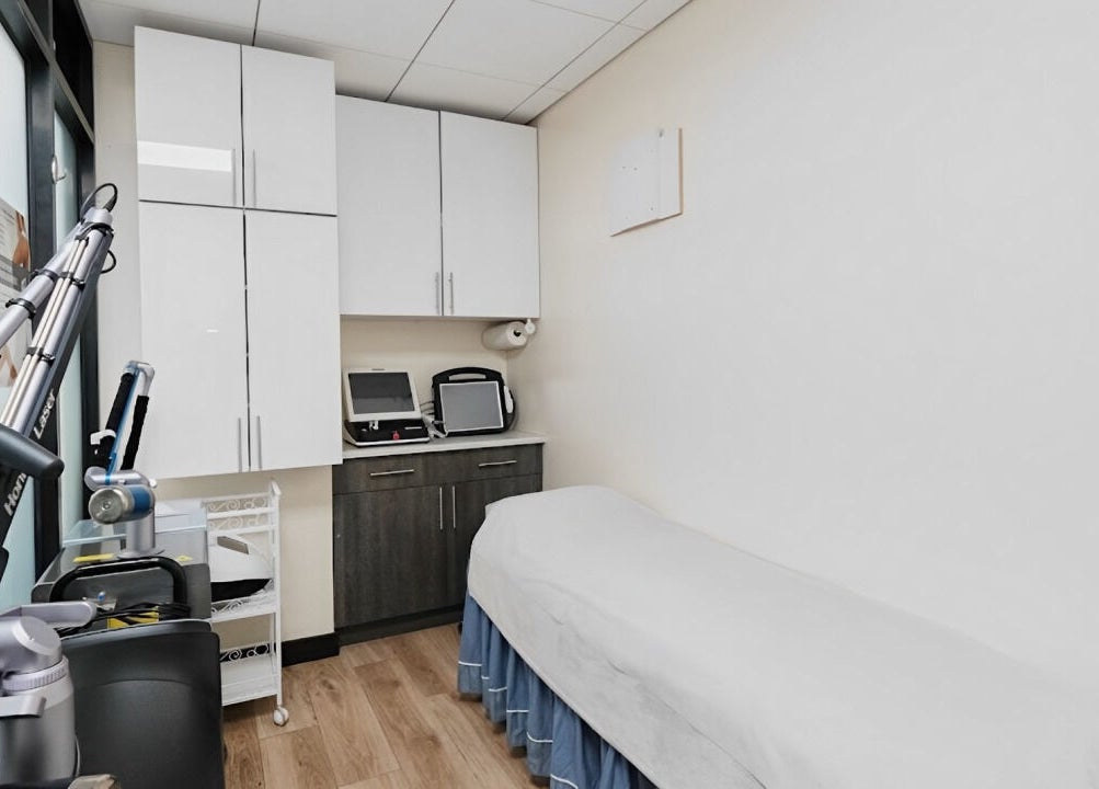 Modern treatment room at HealthKey Group Wellington - Manhattan, New York, US, with spa bed and medical equipment.