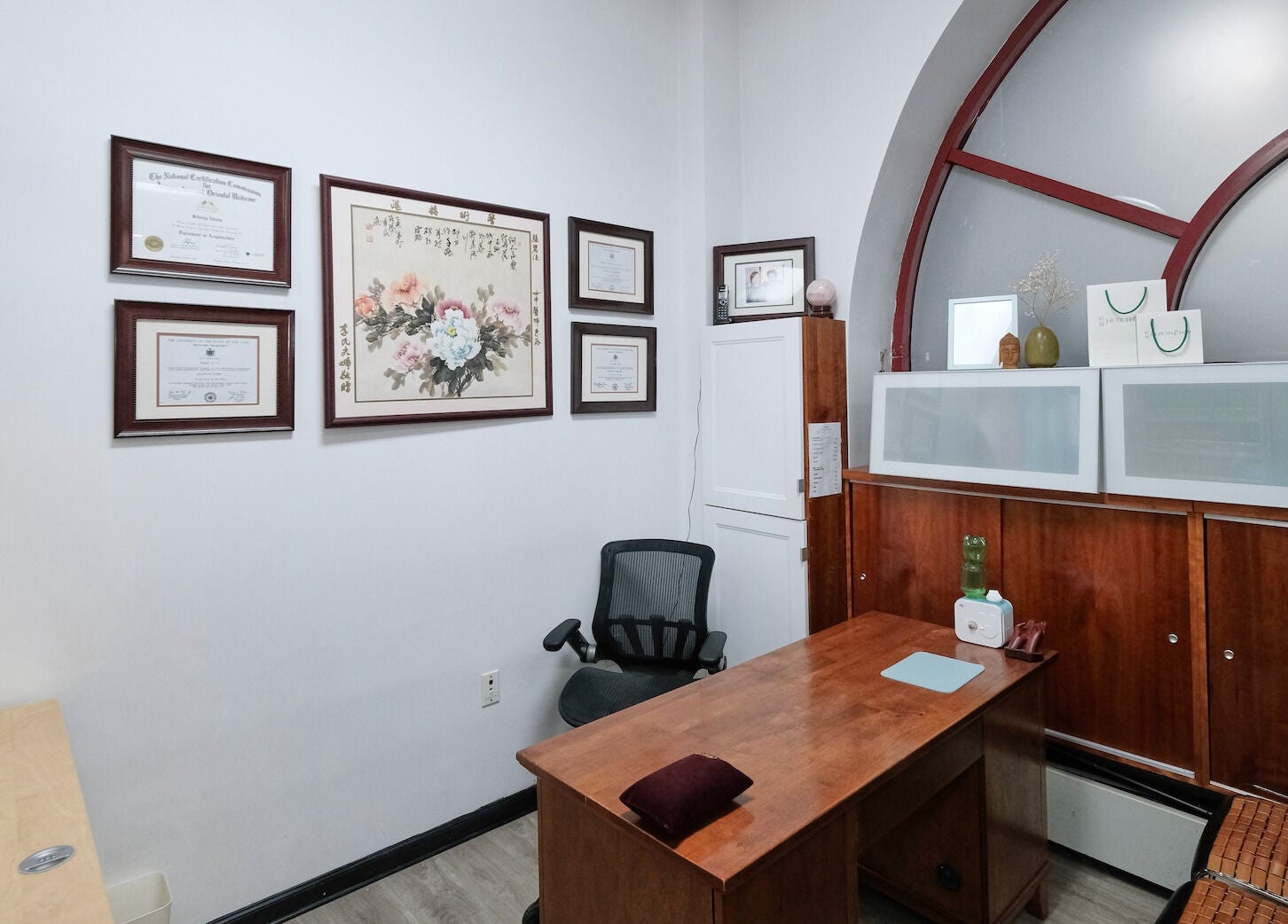 Elegant office at HealthKey Group Wellington - Manhattan, New York, NY, featuring wooden desk and art decor.