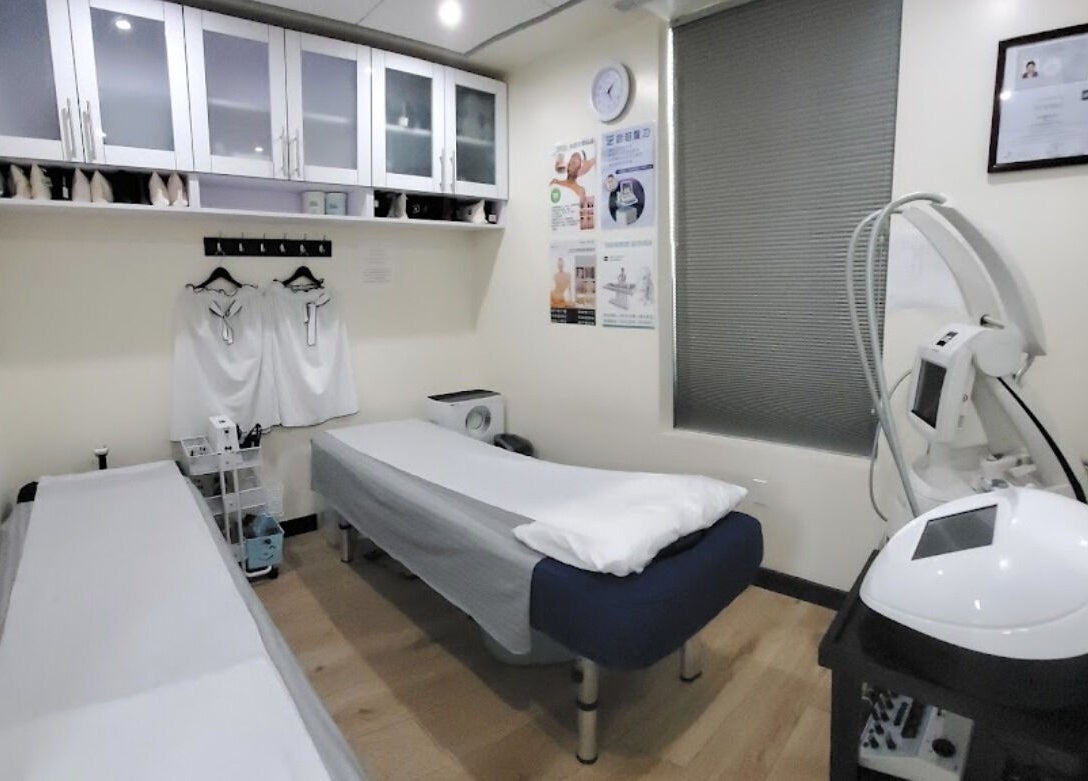A tranquil treatment room at Healthkey Group Medspa - Flushing, featuring modern equipment. New York, New York, US.