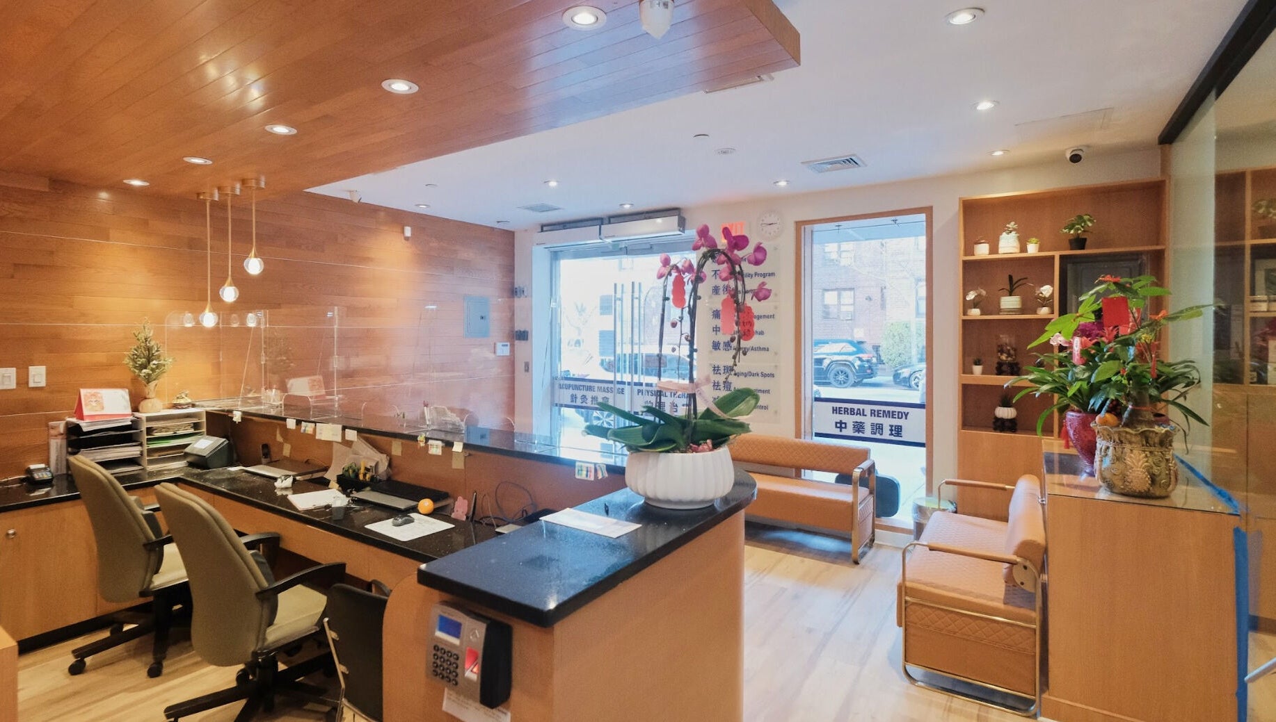 Healthkey Group Wellington - Elmhurst reception area in New York, New York, US, featuring wooden decor and plants.